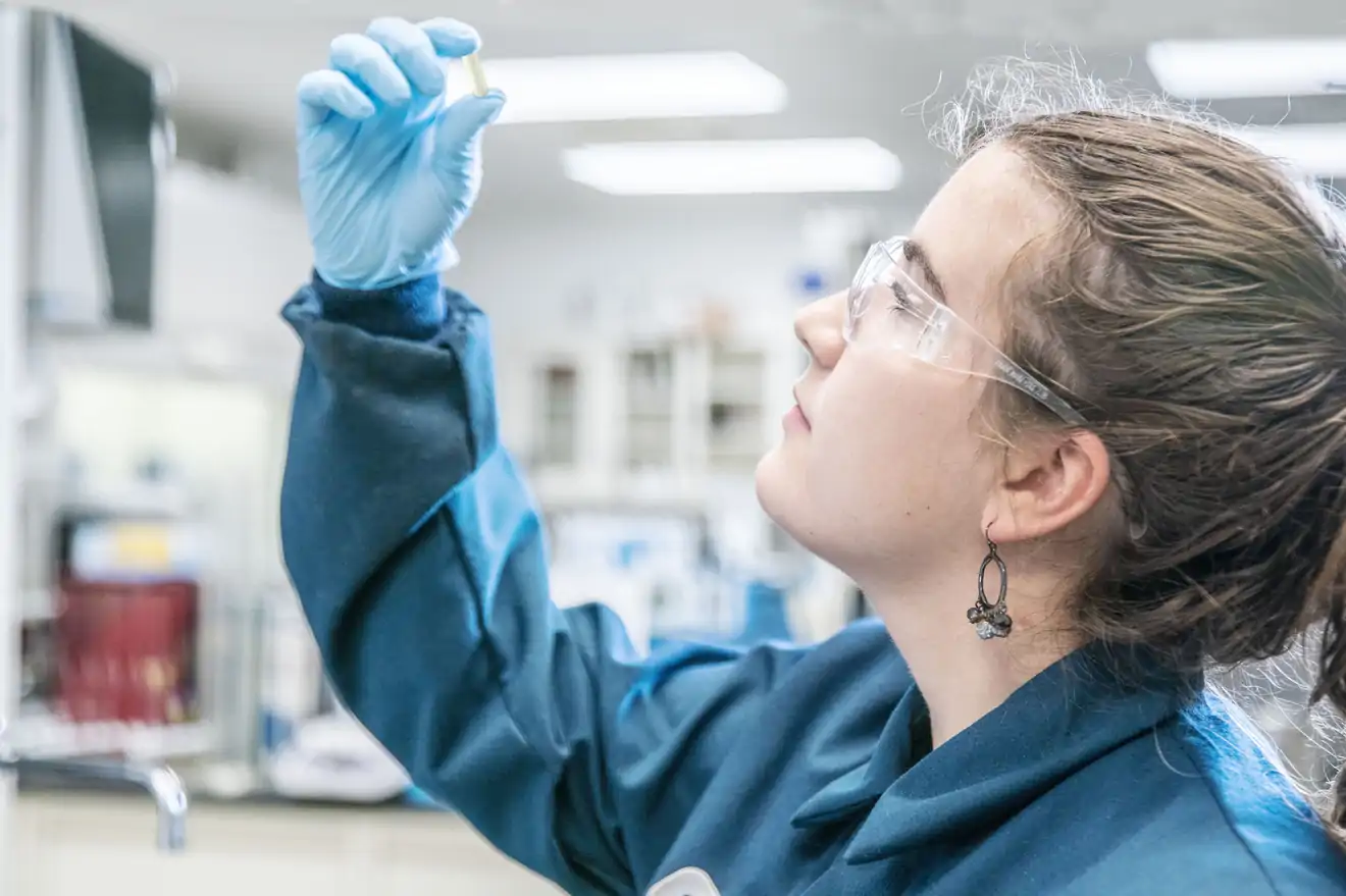 Woman examining capsule